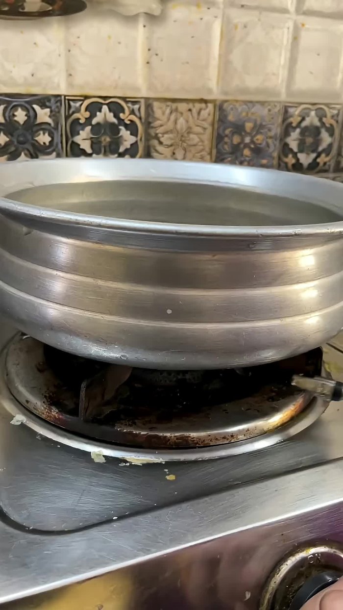 Turn on the stove and bring a large pot to boil.