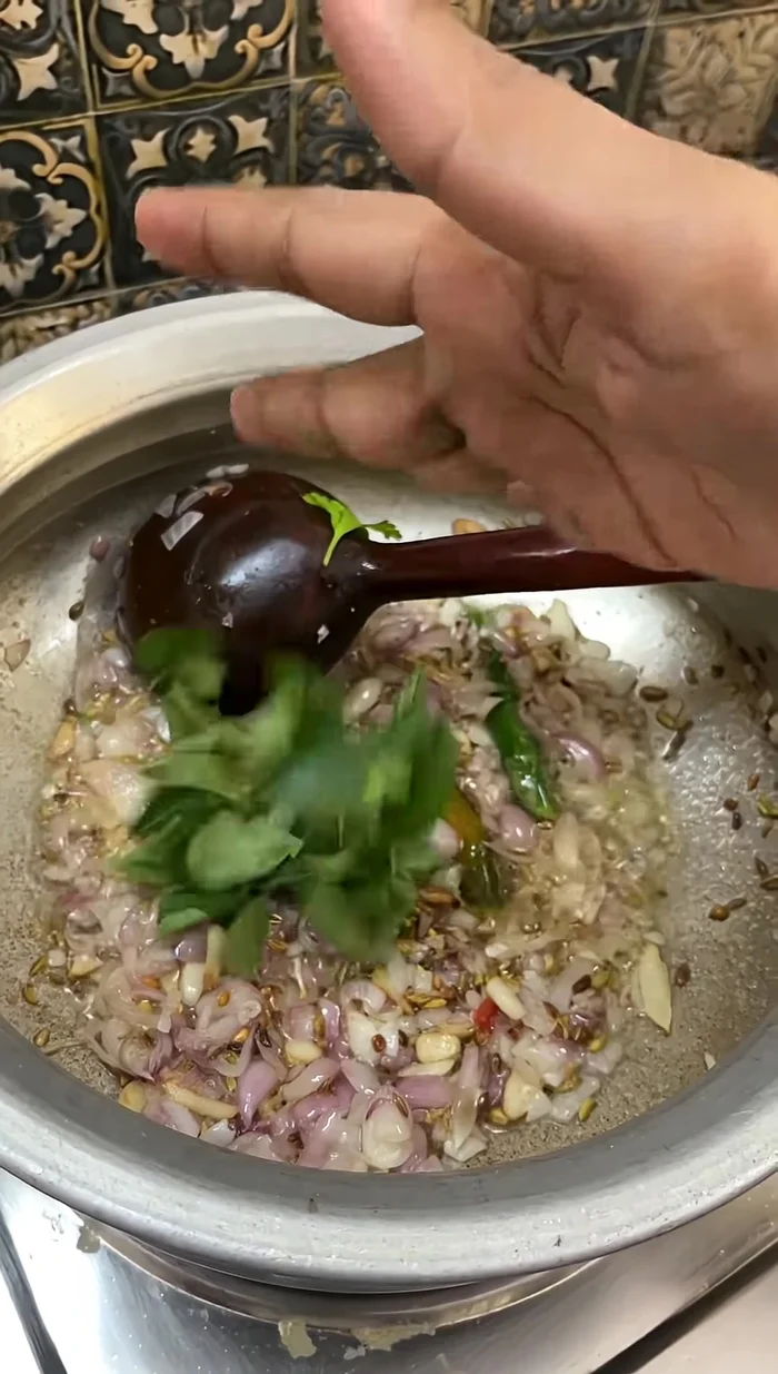Add a bunch of chopped coriander leaves and fry well.