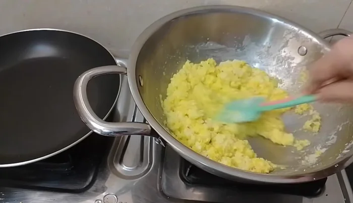 Continue stirring until the mixture thickens into a dough-like consistency.