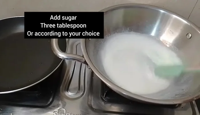 In a pan, combine 1 1/2 cups of milk and 5-4 big spoons of sugar.