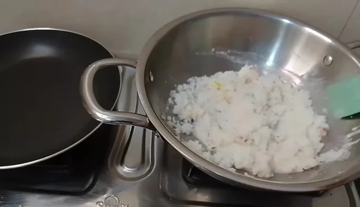 Once the milk thickens, add dry fruits and grated coconut.