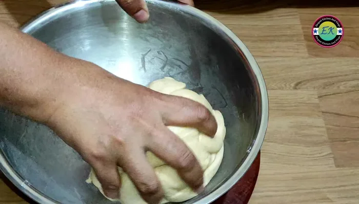 After resting, knead the dough again and form it into balls.