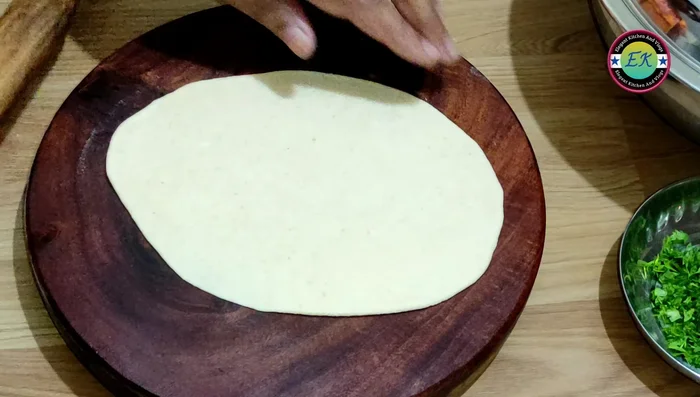 Heat the tawa. Place the naan on the hot tawa, water the back side, and press gently.
