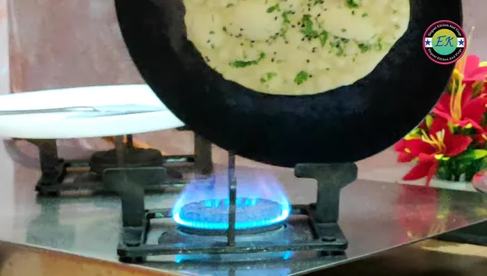 Cook for about a minute on low-medium heat, then flip and cook the other side, rotating the tawa as needed. Maintain low-medium heat to prevent burning.