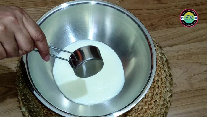 In a large bowl, combine yogurt, milk, sugar, salt, baking powder, baking soda, and 1 tablespoon of oil. Mix well.