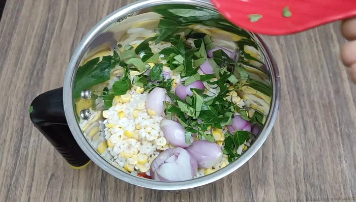 Add peeled and sliced onions, curry leaves, coriander leaves, salt, and cumin to the mixer jar.