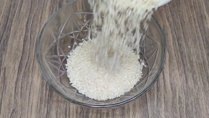 Add idli rice (or brown rice), chickpeas, and black gram to a mixing bowl. Wash thoroughly two to three times.