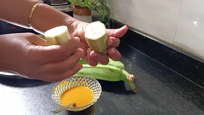 In a bowl, mix one spoon of salt, a little more than half a spoon of turmeric, and half a cup of water. Mix well.