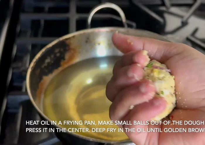 Heat oil in a frying pan. Take small, lemon-sized portions of the mixture, flatten slightly, and carefully drop into the hot oil.