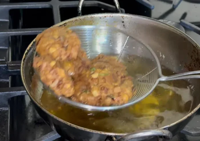 Fry over medium heat until golden brown on both sides, ensuring they are cooked through. Avoid overly hot oil to prevent burning the outside before the inside cooks.