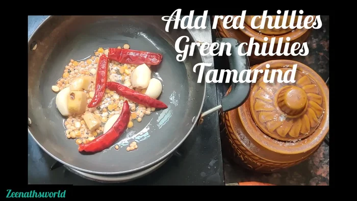 Add 2 green chilies and 2 red chilies.