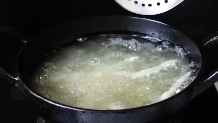 Heat oil in a pan. Fry the vadas until golden brown and crispy.