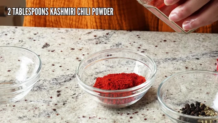 Blend the onion mixture with Kashmiri chili powder (1.5-2 tbsps), and a cup of water until smooth. (Alternatively, finely chop the onion and use ground spices instead of whole.)