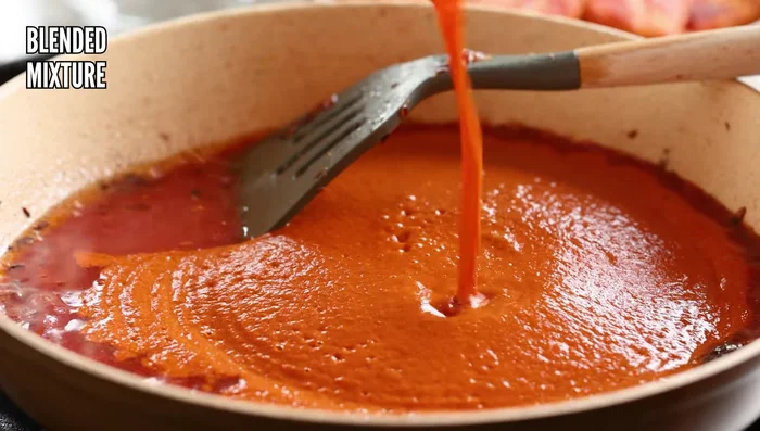 Add tomato puree and the blended onion mixture. Rinse the blender with ½ cup water and add to the skillet. Add salt and ground spices (and hing, if using).