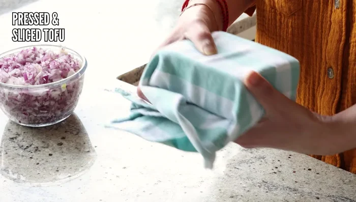 Press and slice or tear the tofu. If slicing, aim for thick, flat slices for a closer resemblance to lal paneer.