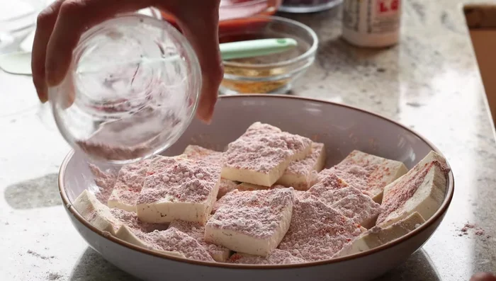 Crisp the tofu in a skillet with oil over medium-high heat for 2-3 minutes per side, until golden brown.