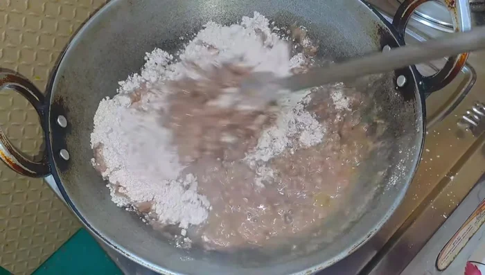 Once the water boils, add ragi flour and mix immediately with a spatula. Keep flame high.