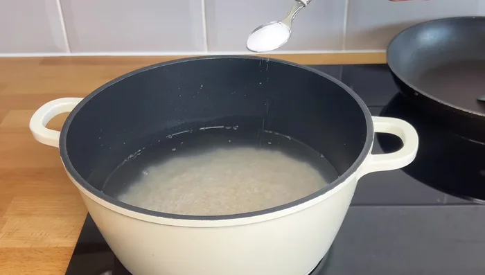Boil rice with water. Add salt, oil, bay leaf, and onion once the water is reduced.