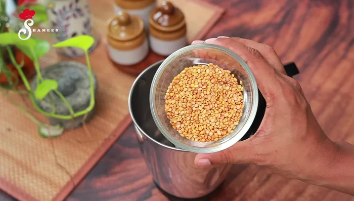 Lightly roast the chickpeas until light brown. Grind them finely in a mixer.