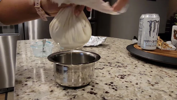 Strain the yogurt to make hung curd. This step is done early in the morning (67.439).