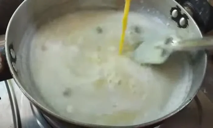 Slowly pour the custard mixture into the milk while constantly stirring to prevent lumps. Continue cooking for 2-3 minutes until slightly thickened.