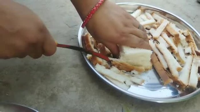 Cut bread edges and slice bread into two pieces.