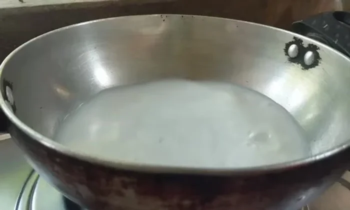 In a separate pan, heat milk. Add crushed cardamom.
