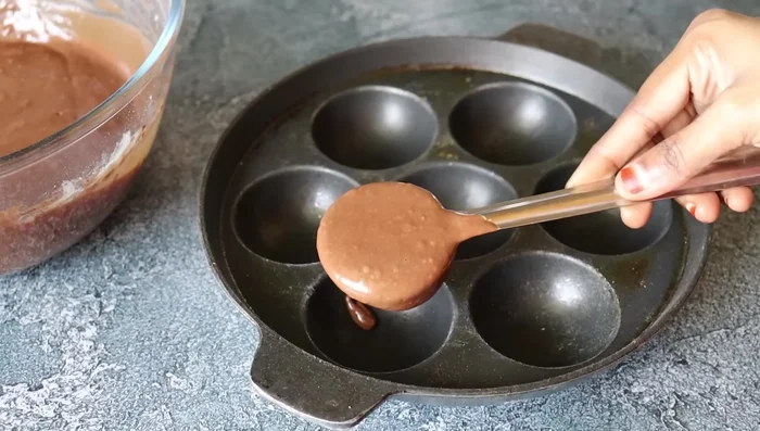 Grease a paniyaram pan.