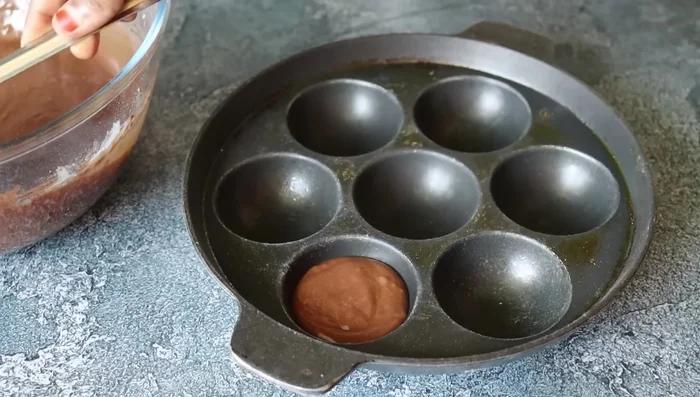 Pour batter into each well, filling ¾ full. Add chocolate pieces on top.