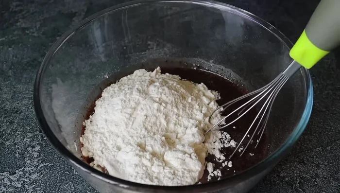 Add maida flour, baking powder, and baking soda. Mix until smooth and lump-free. (Mix in one direction only)
