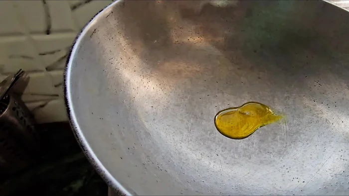 Heat mustard oil in another pan, add cumin seeds and bay leaves, and let them crackle.