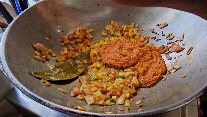 Add the ground spice mixture, ginger, and garlic to the onions.