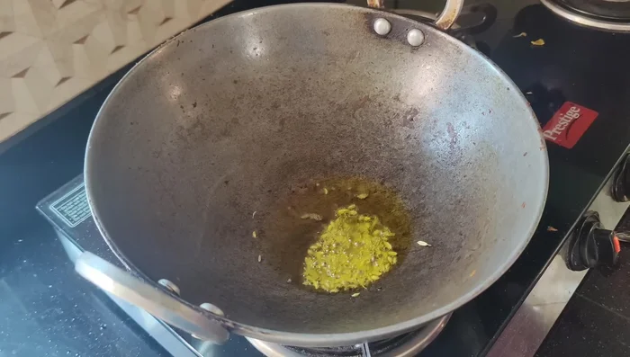 Heat oil in a pan, add the paste, and fry.