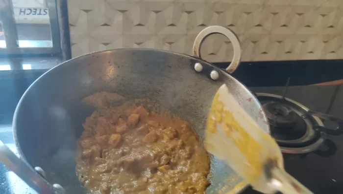 Drain excess water and fry the potatoes in the masala.