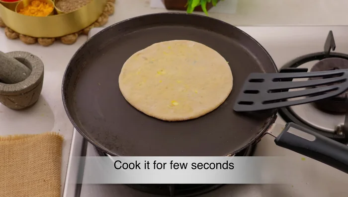 Heat a pan. Cook the paratha for 10-12 seconds on each side, applying ghee or oil as needed.