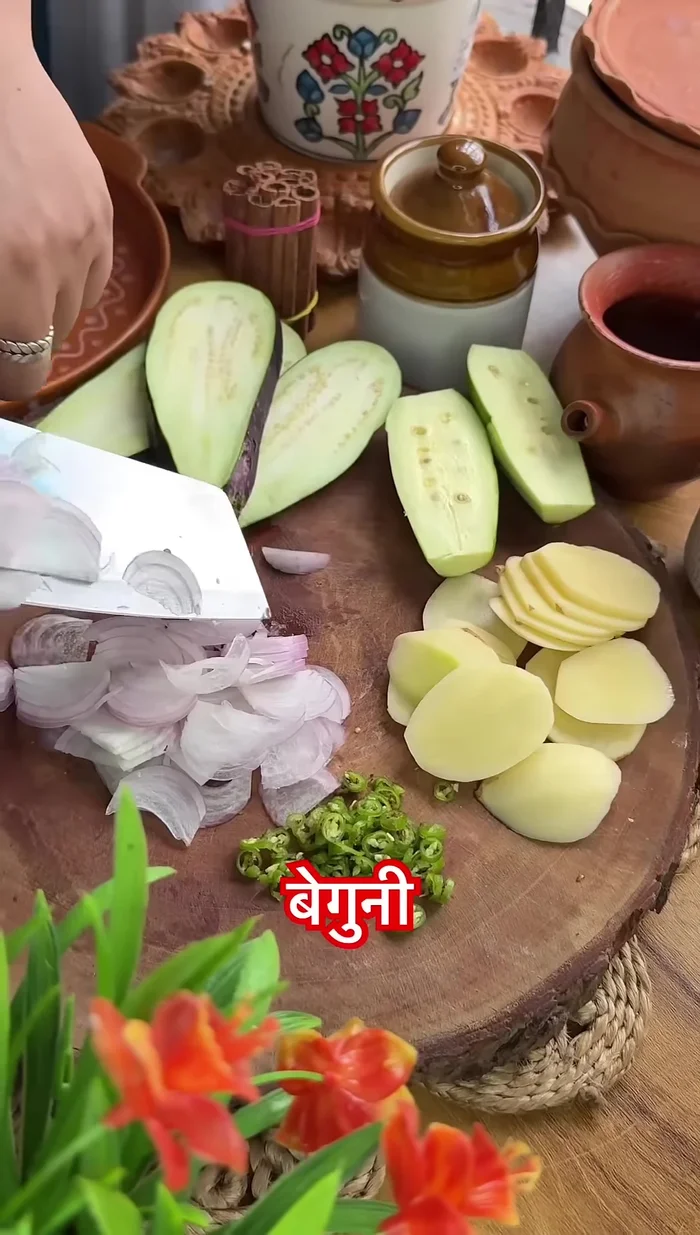 Prepare beguni (eggplant fritters) by mixing them in gram flour batter and frying.