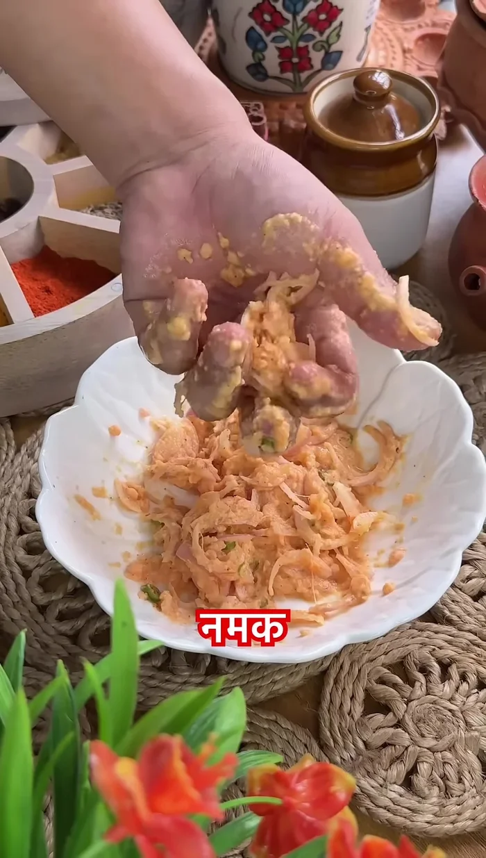 Fry the lentil paste by adding onion, green chili, salt, and red chili.