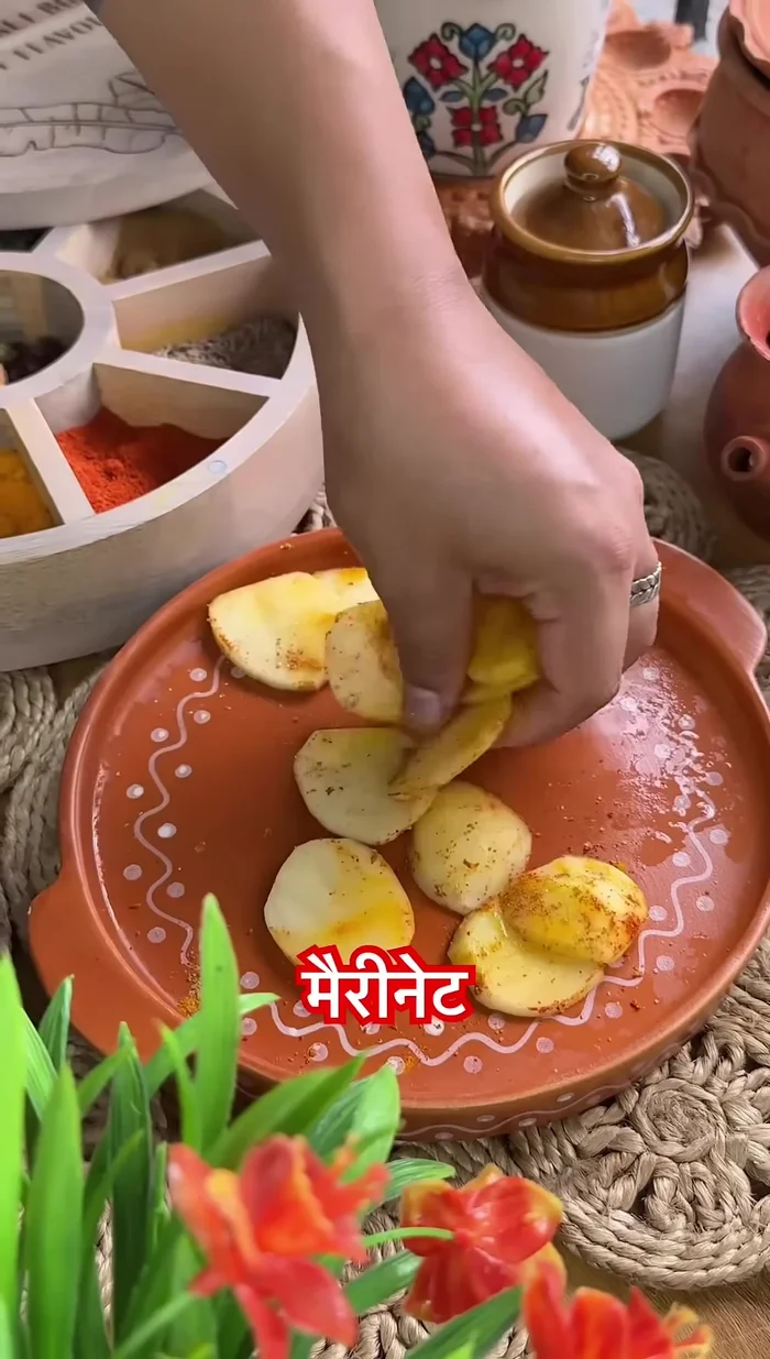 Marinate the remaining potatoes and potal with turmeric, salt, and red chili powder.