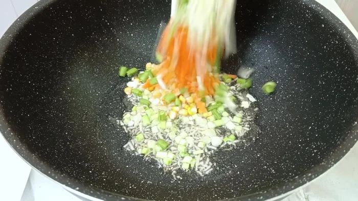 Add the vegetables (cabbage, beans, carrots, corn) and fry until soft.