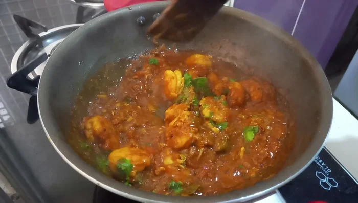 Add chopped coriander leaves. Stir and check if the curry is thick enough.