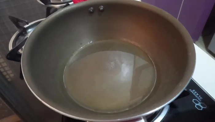 Heat oil in a pan. Fry the shrimp in batches until lightly browned, avoiding overcooking.