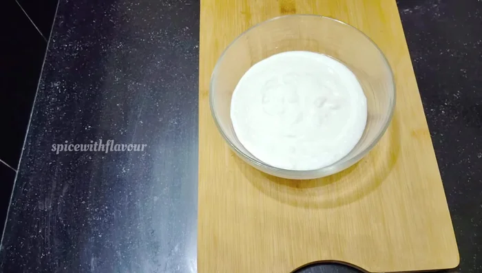 In a bowl, whisk together 2 cups of thick, fresh curd until smooth.