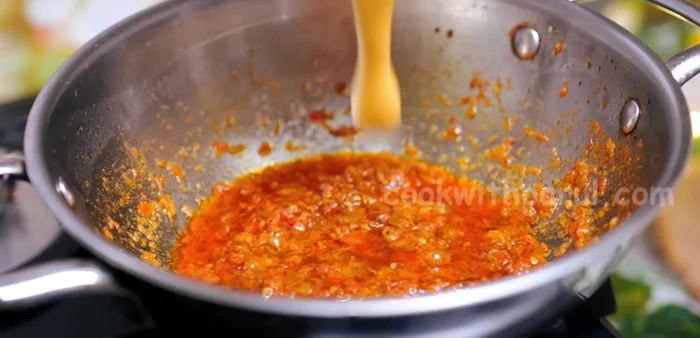 Add 1/4 cup water to reduce the heat, then add the curd paste. Stir continuously and bring to a boil.