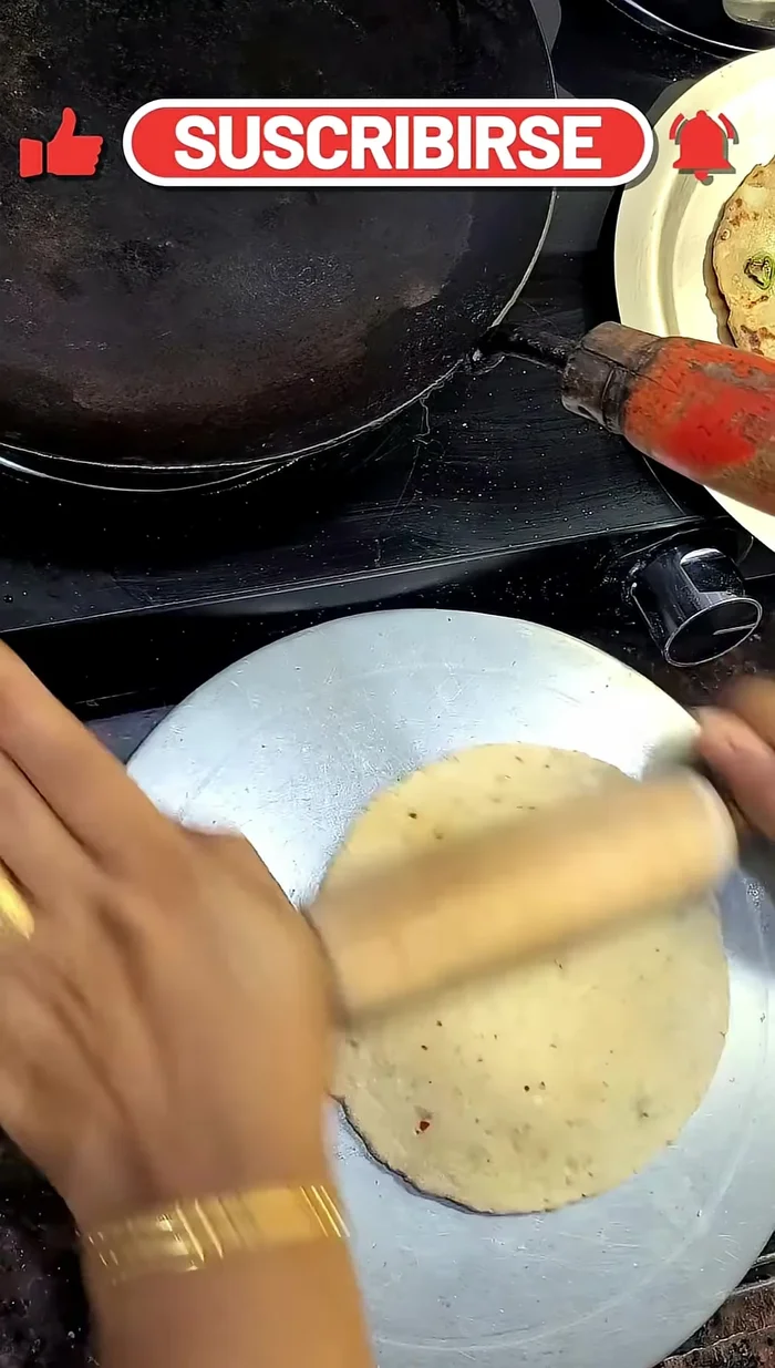 Roll out the dough into flat circles like rotis.