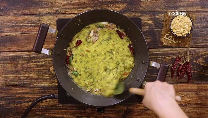 Pour the tempering over the cooked dal and stir (151.84). Simmer for 1-2 minutes (156.8).