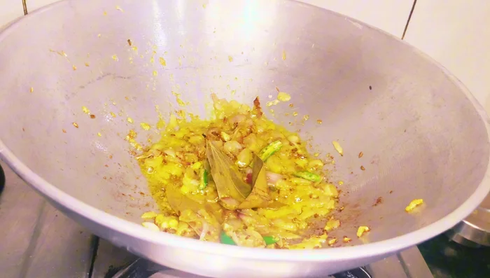 Add lengthwise-cut green chilies, then add finely chopped tomatoes, salt, and stir well.