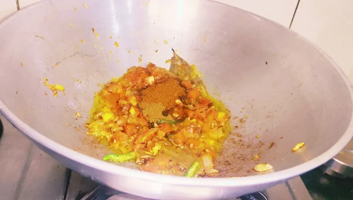 Add garam masala, cumin powder, black pepper powder, coriander powder, and red chili powder. Stir to prevent burning.