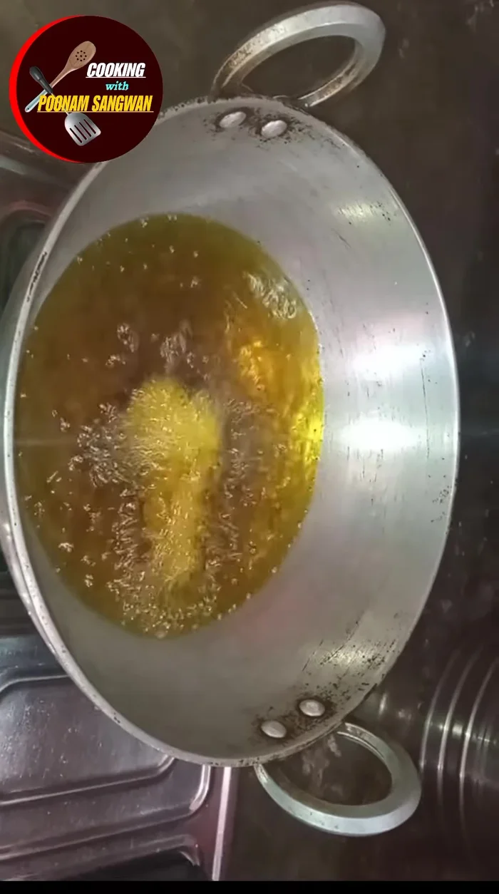 Take small portions of the mixture and drop them into the hot oil.