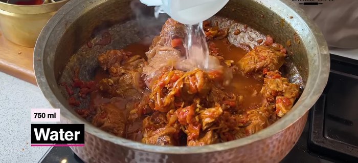 Add 750 ml water and salt. Stir, cover, and cook until the mutton is almost done.