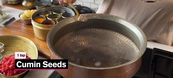 Heat half a cup of oil. Once hot, add cumin seeds and potatoes (pre-prepared). Fry until golden brown. Remove.